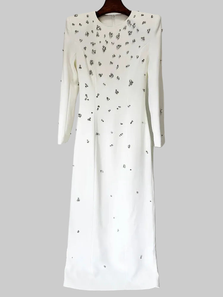 White dress with black floral patterns on a hanger against a white background