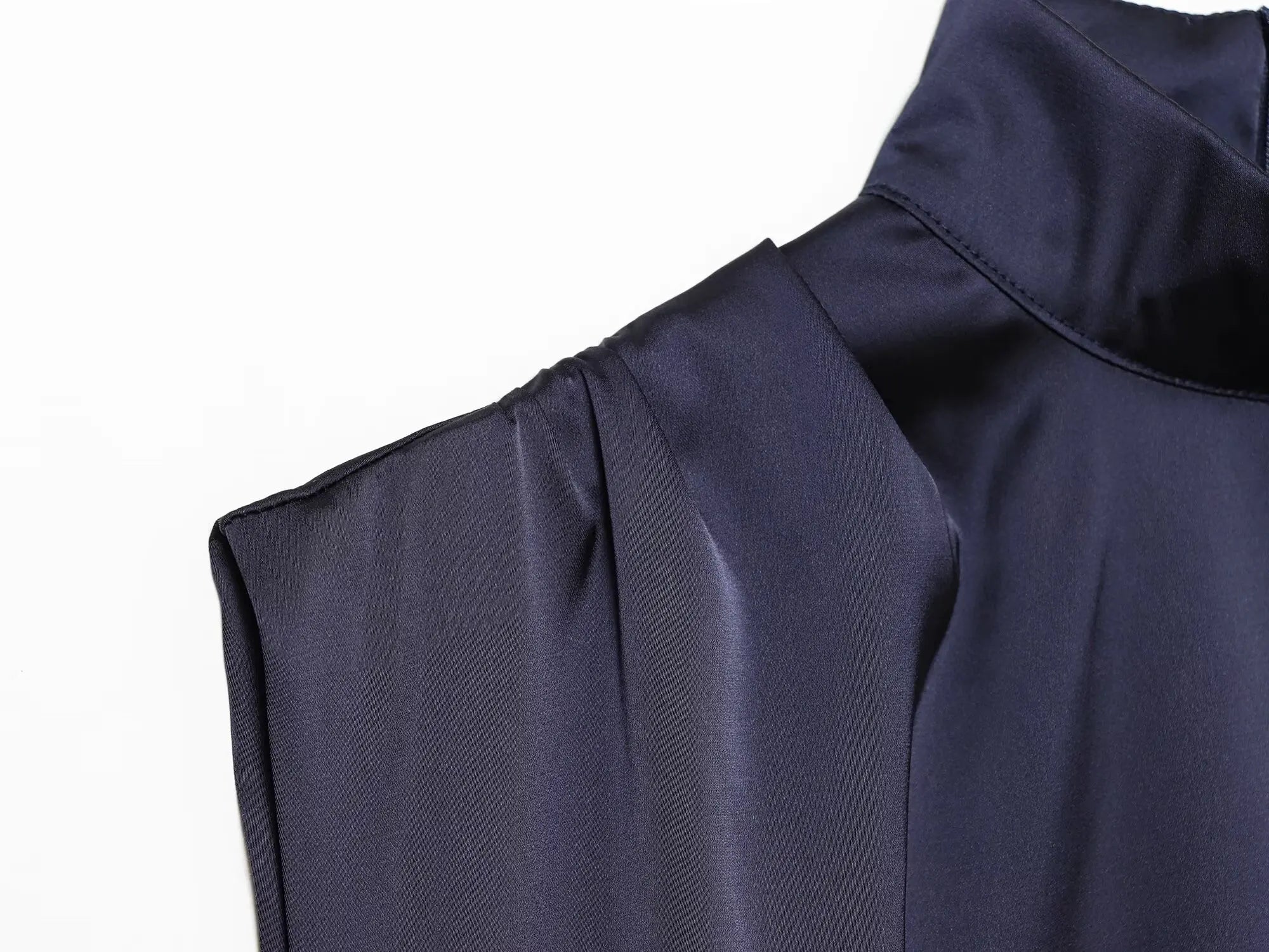 Navy sleeveless dress with lace trim on a white background