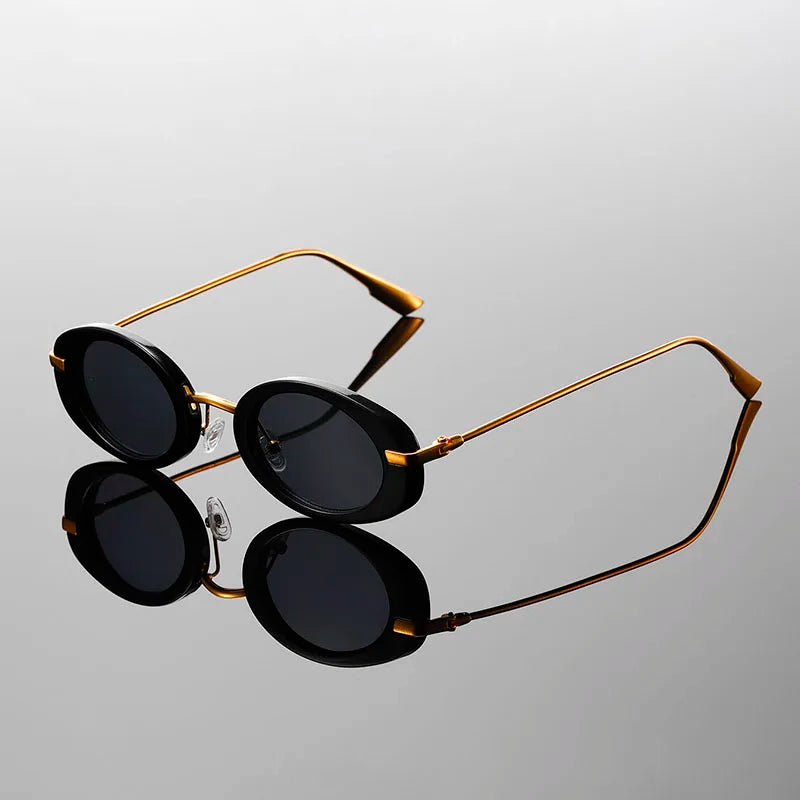 Side profile of black retro round sunglasses showing design