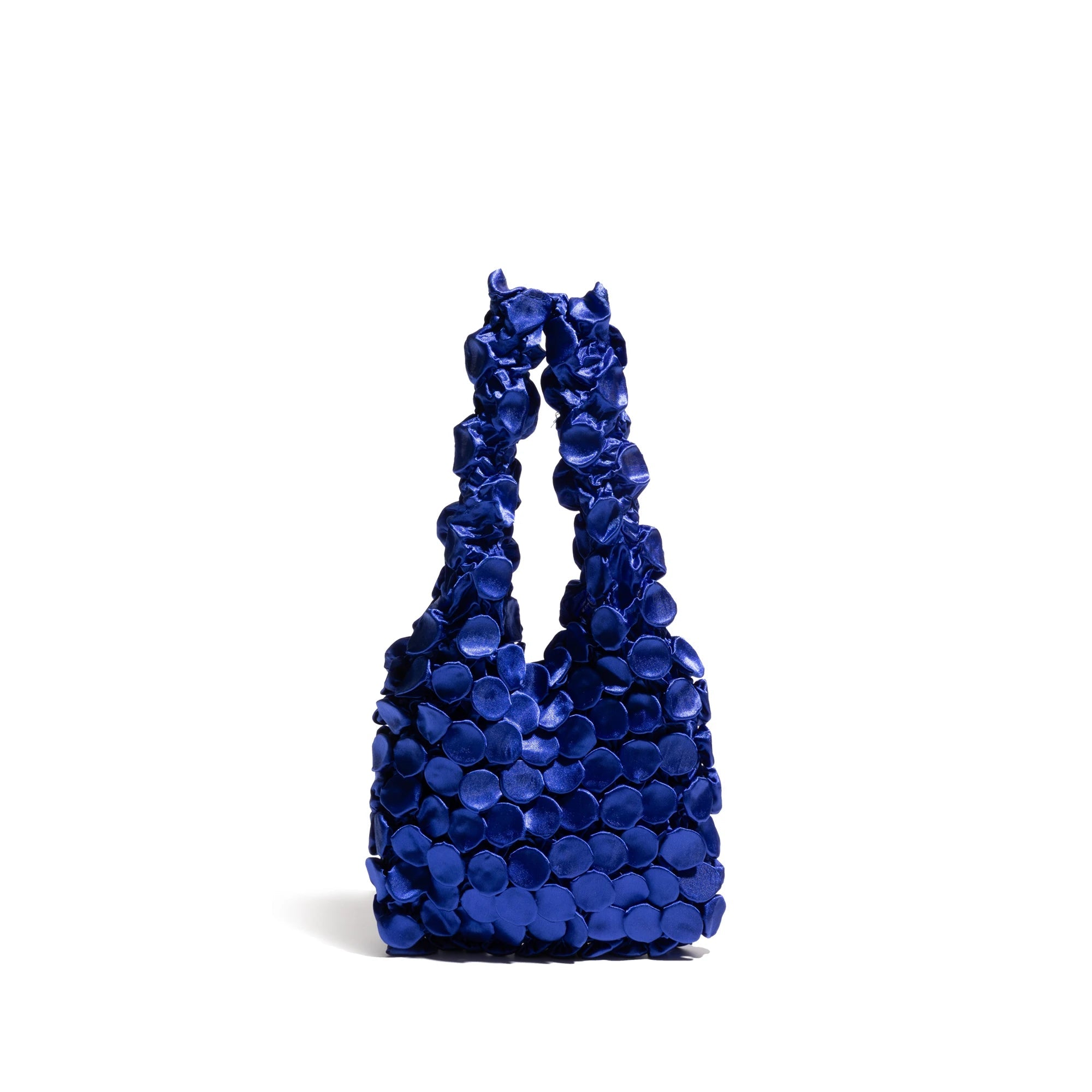 Blue handbag with flower-like handles on a white background