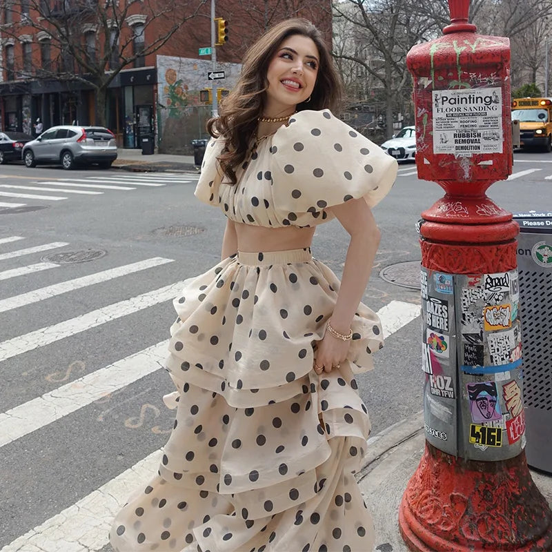 Woman wearing Noemi white polka dot set with black dots and puffy sleeves, front view