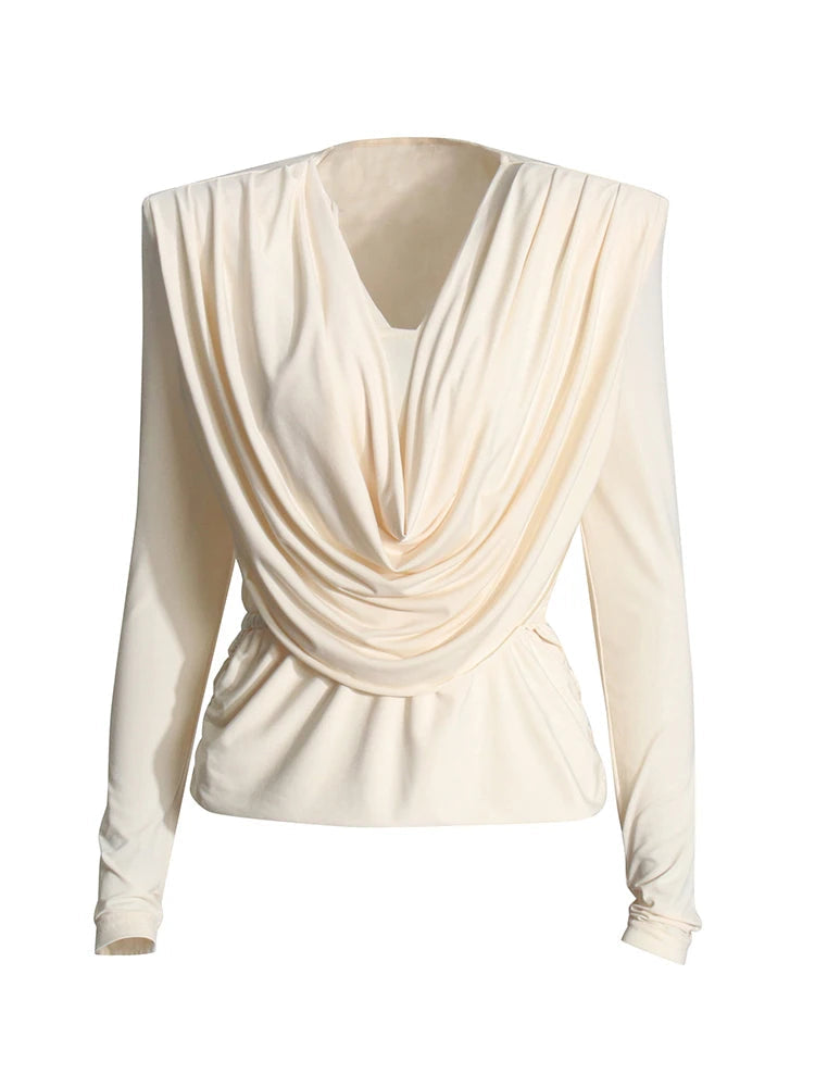 Cream-colored long-sleeve top with draped design on a white background.