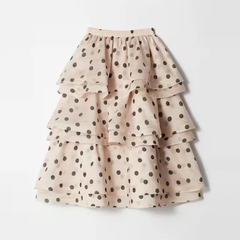 Complete styling view of woman wearing Noemi white polka dot pleated set with accessories