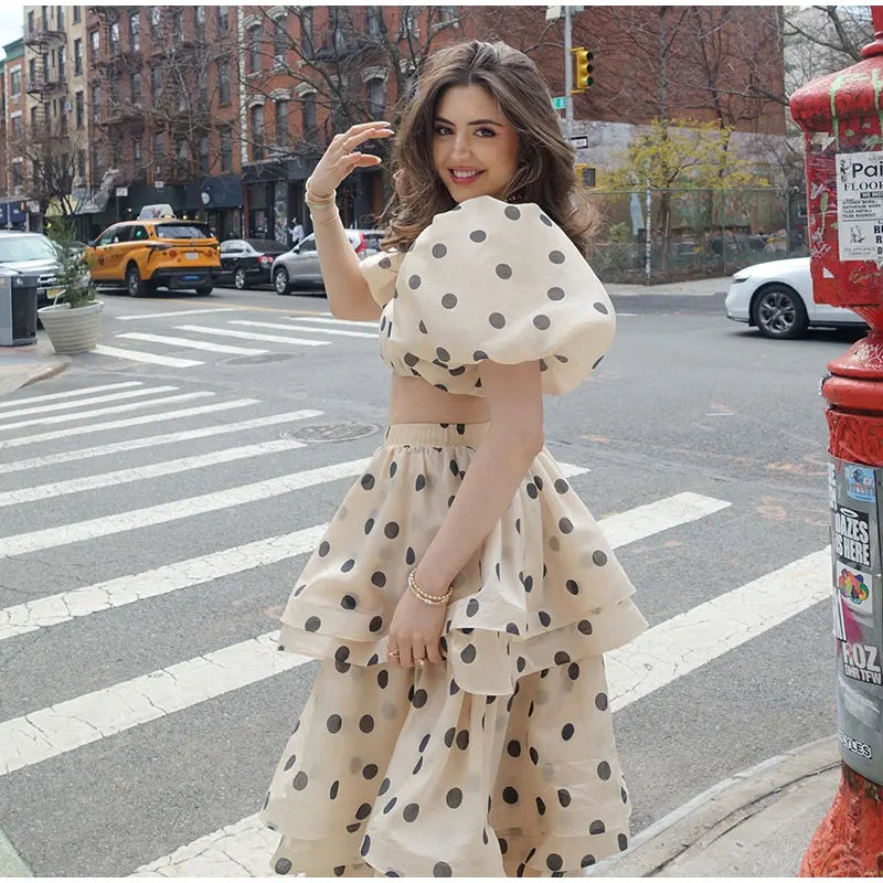 Back view of Noemi white polka dot set showing pleated skirt and button details