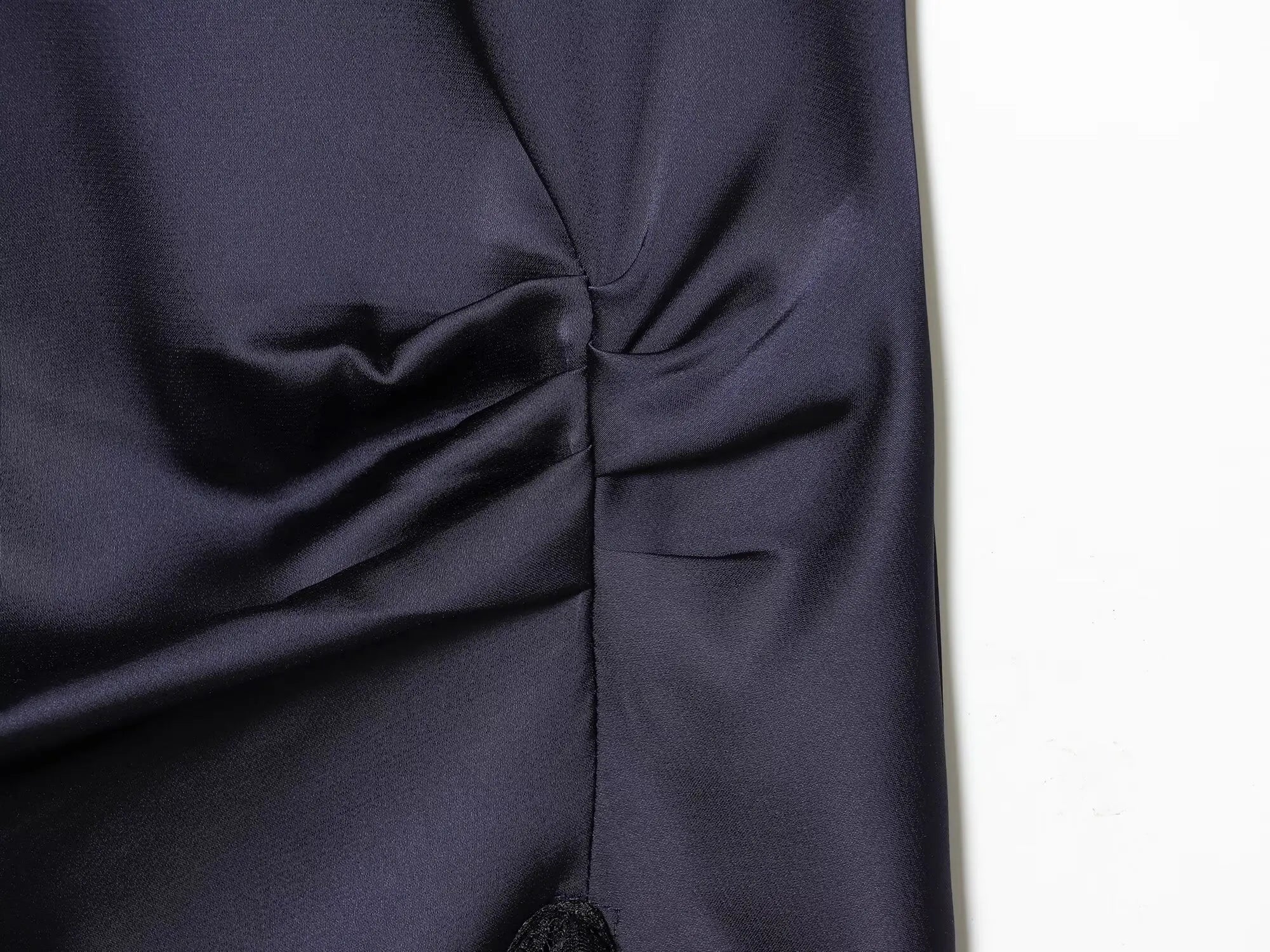 Navy sleeveless dress with lace trim on a white background