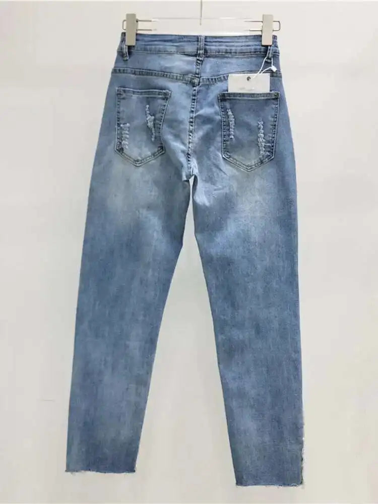 Blue jeans with glittery cuffs on a white background