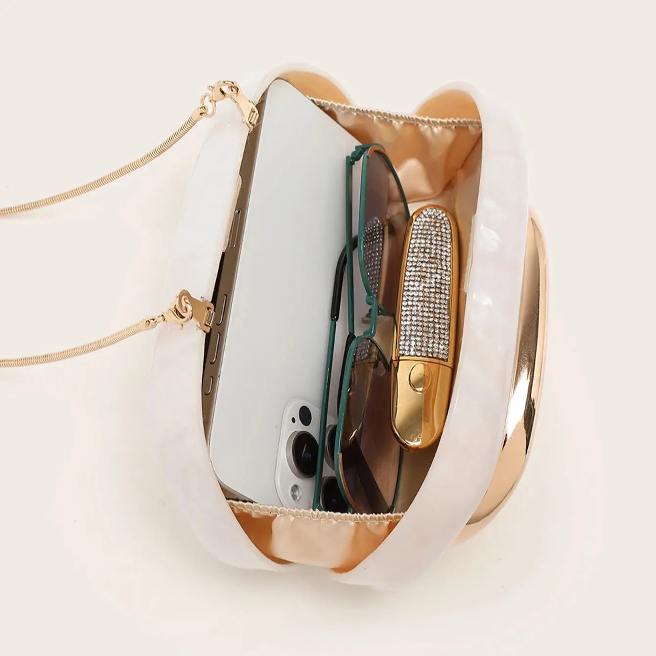 Side profile of metal handle clutch bag showing depth and structure
