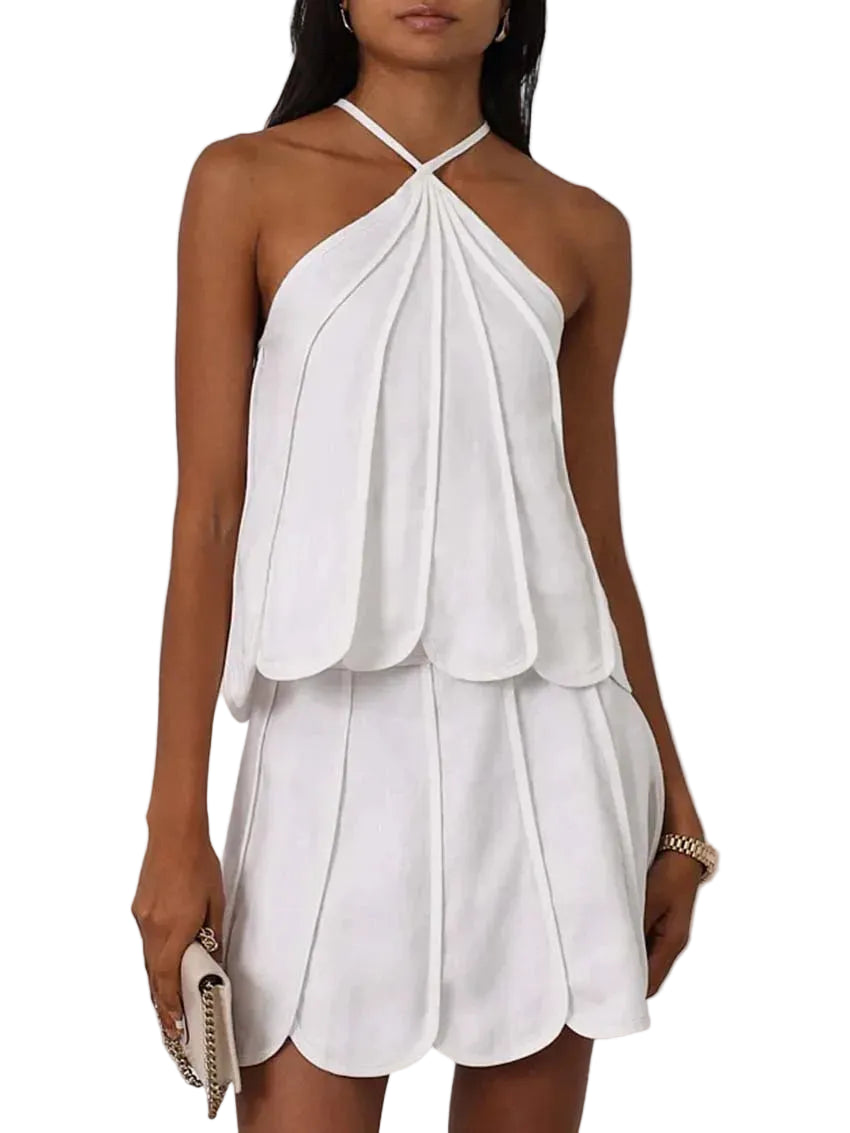 White halter neck dress worn by a model on a plain background