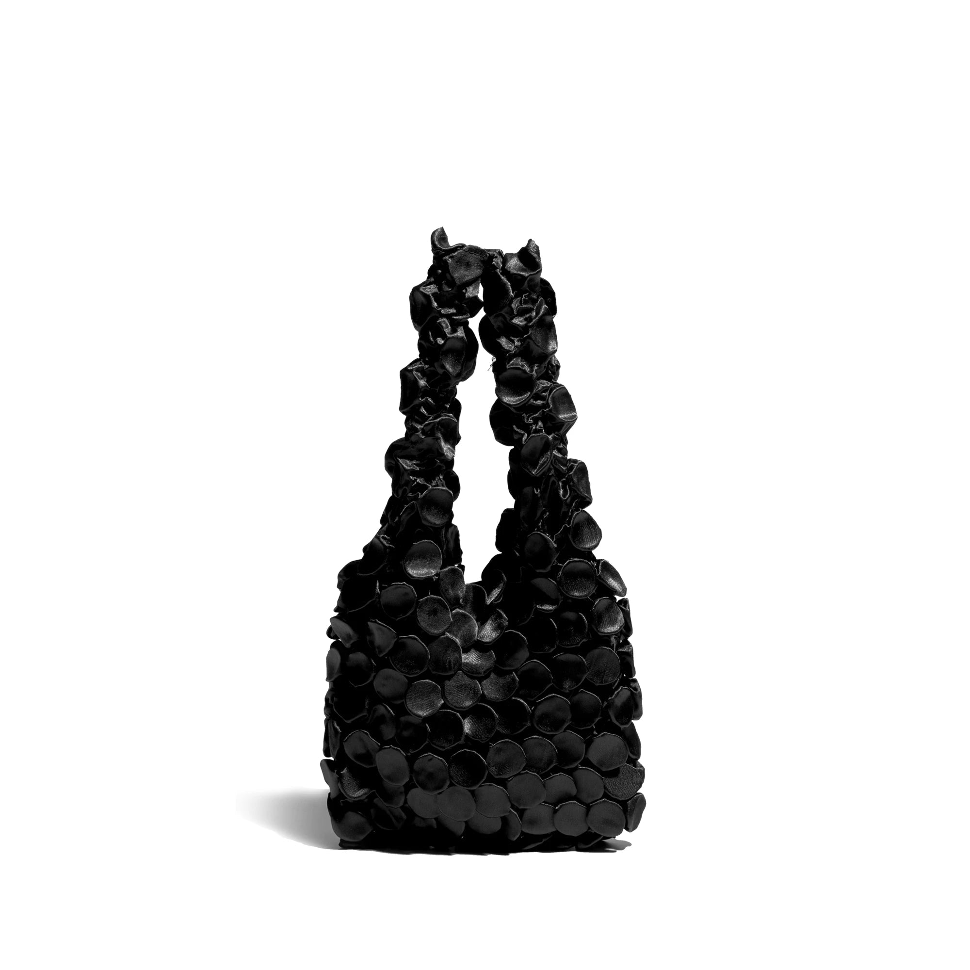 Black handbag with floral design on a white background