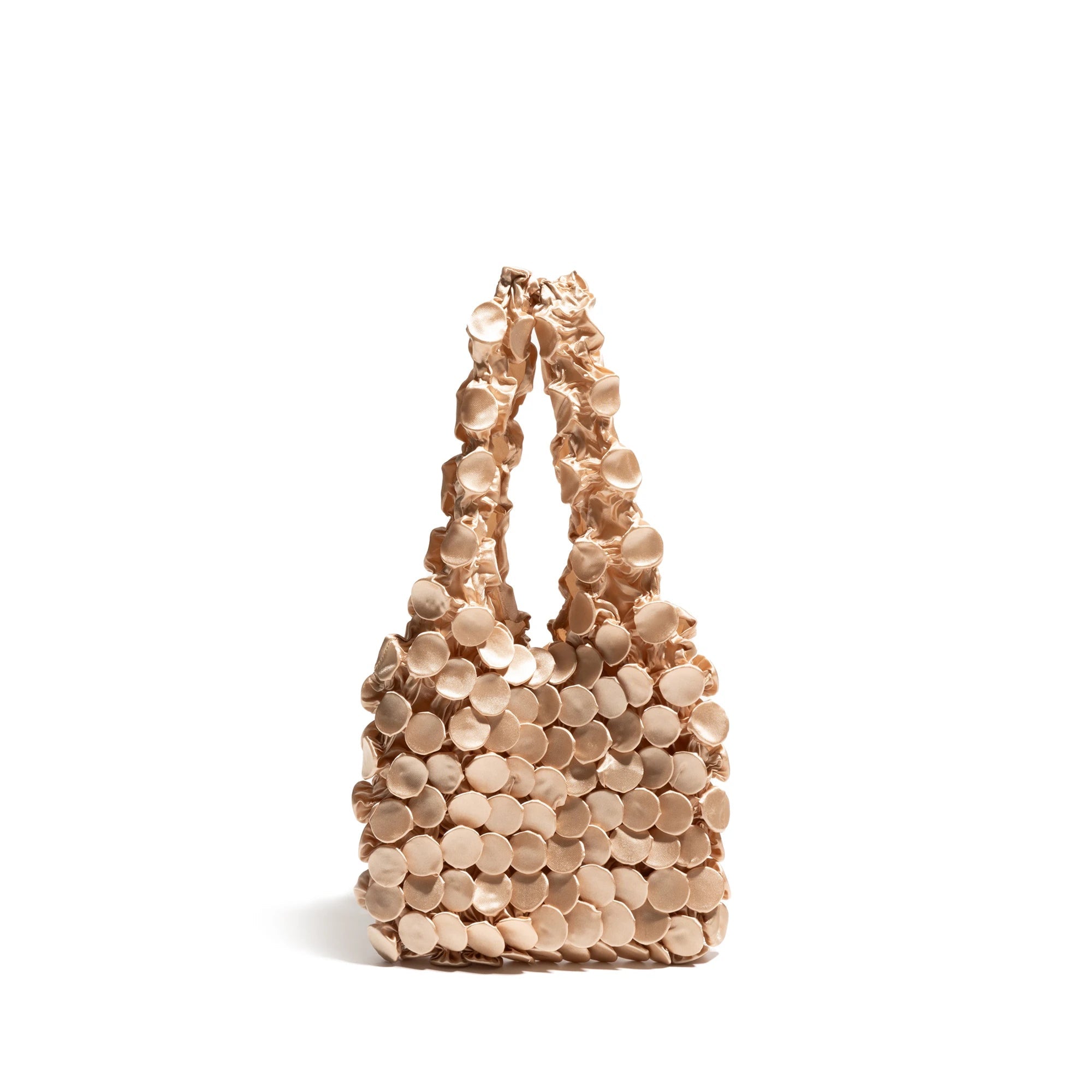 Beige handbag with circular patterns on a white background