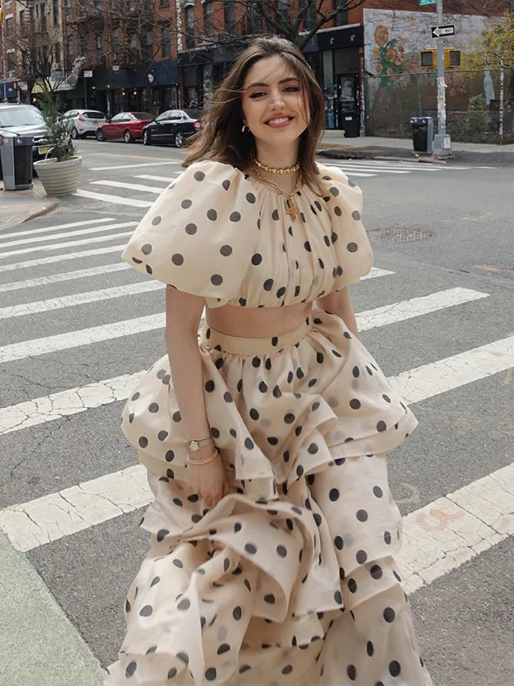 Pleated skirt detail of Noemi white polka dot set with A-line silhouette