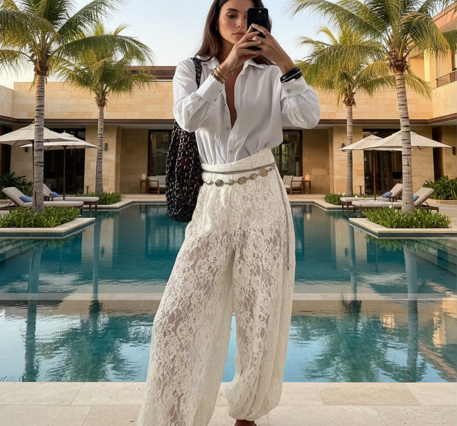 Person wearing a white blouse and lace pants