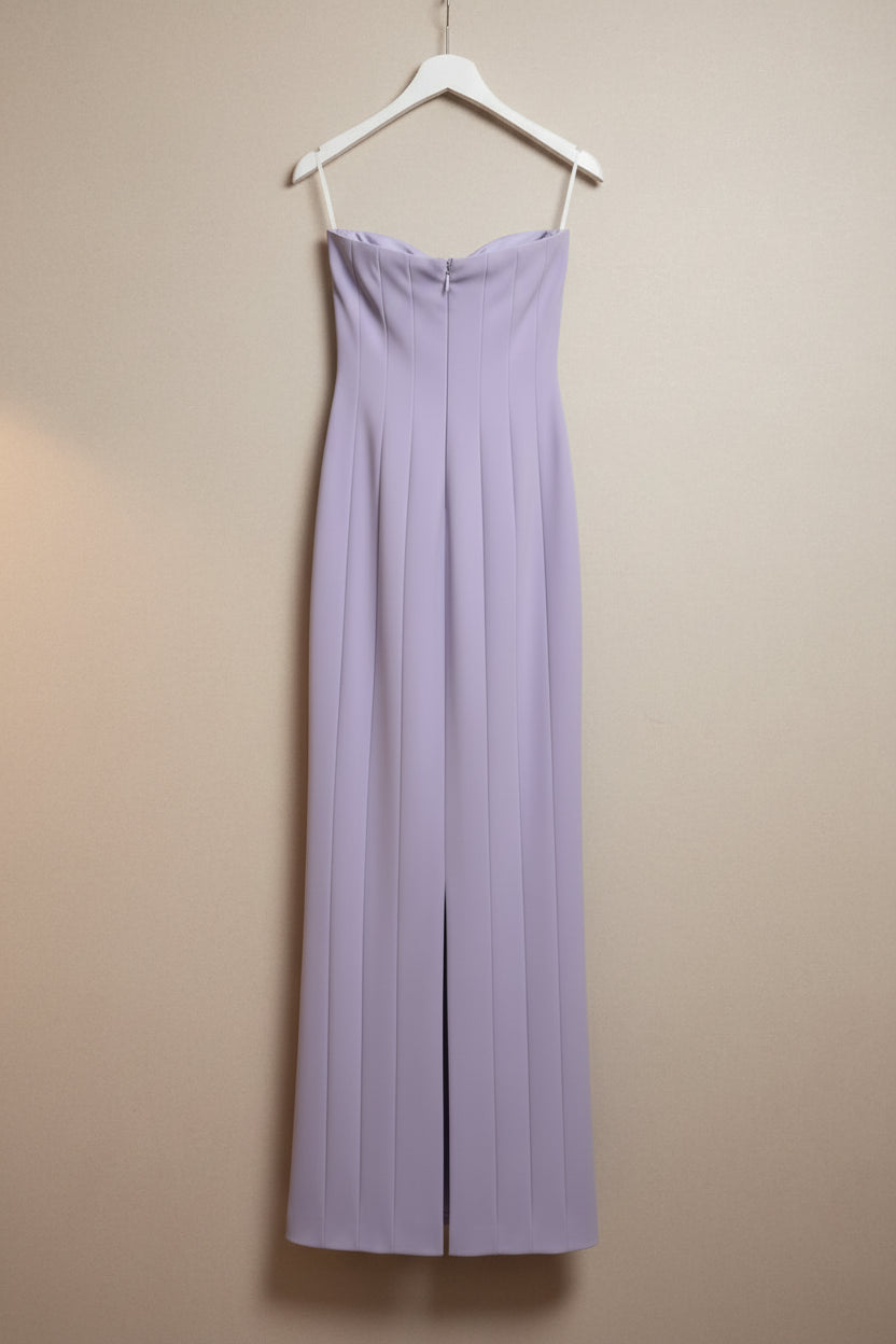 Lavender dress on a hanger against a white background
