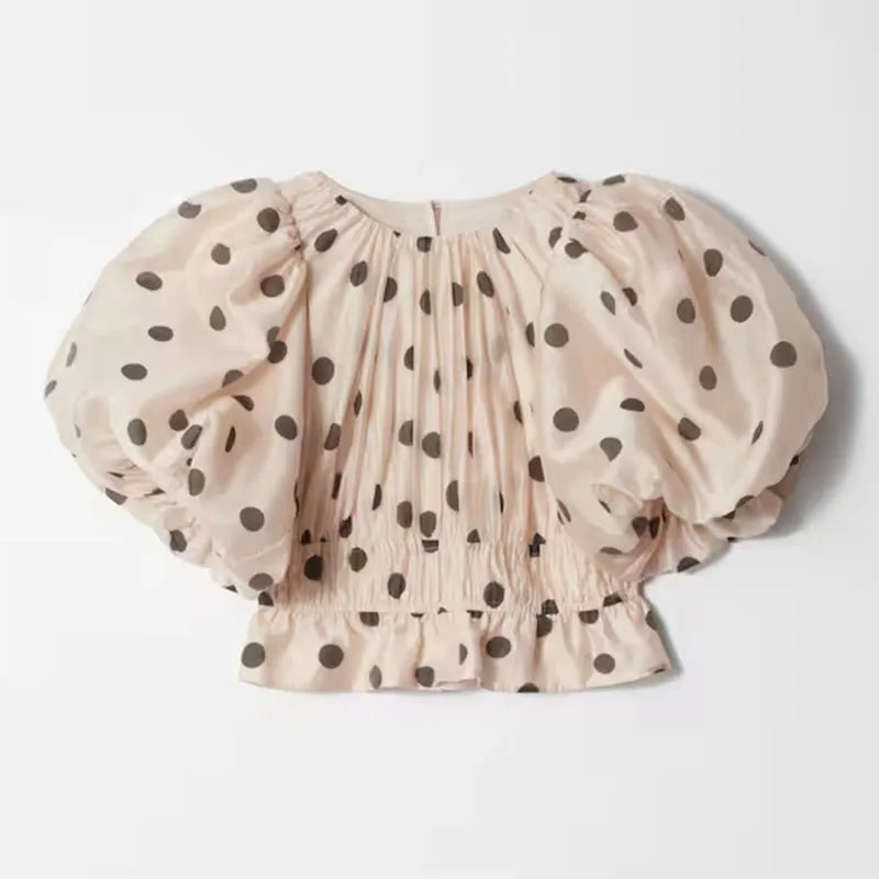 Sleeve cuff and puffy design detail of Noemi polka dot top